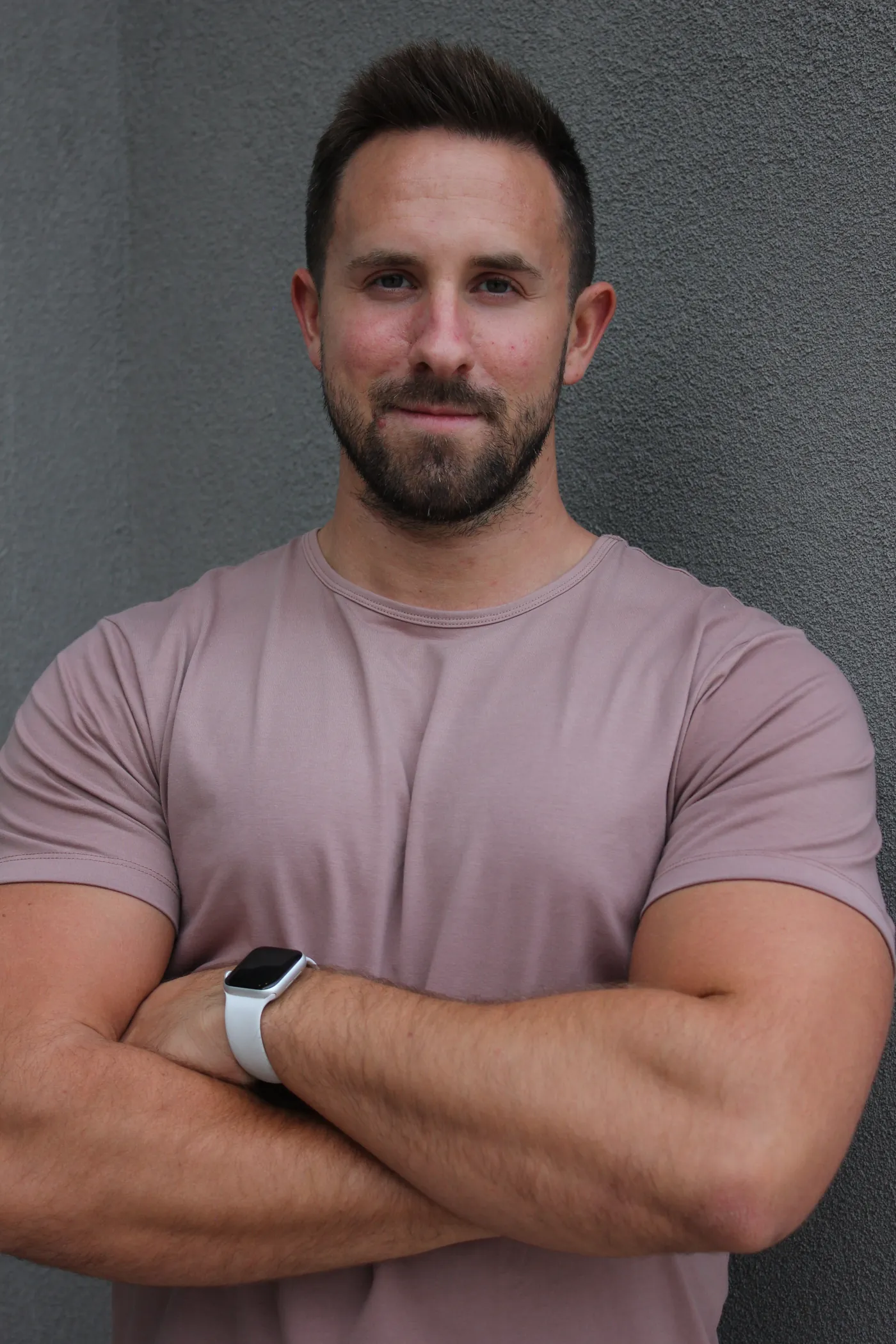 Tyler Weader smiling with arms crossed